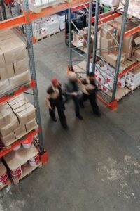 three people in a warehouse