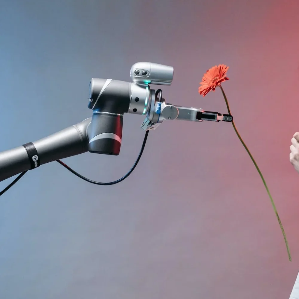 Machine Learning Robot holding a flower in front of a girl
